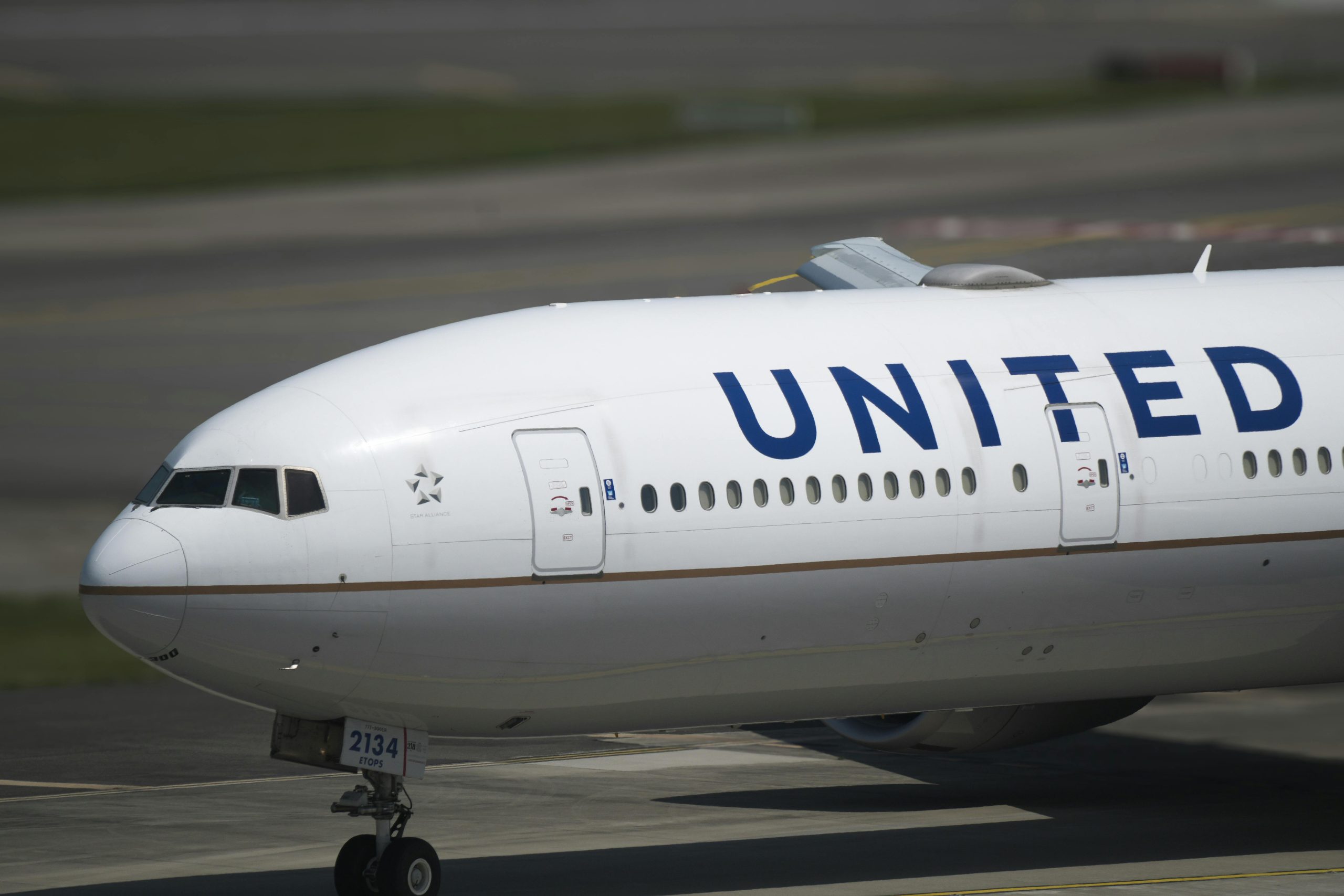 Close-up of a United Airlines airplane on taxiway, emphasizing the aircraft's details.