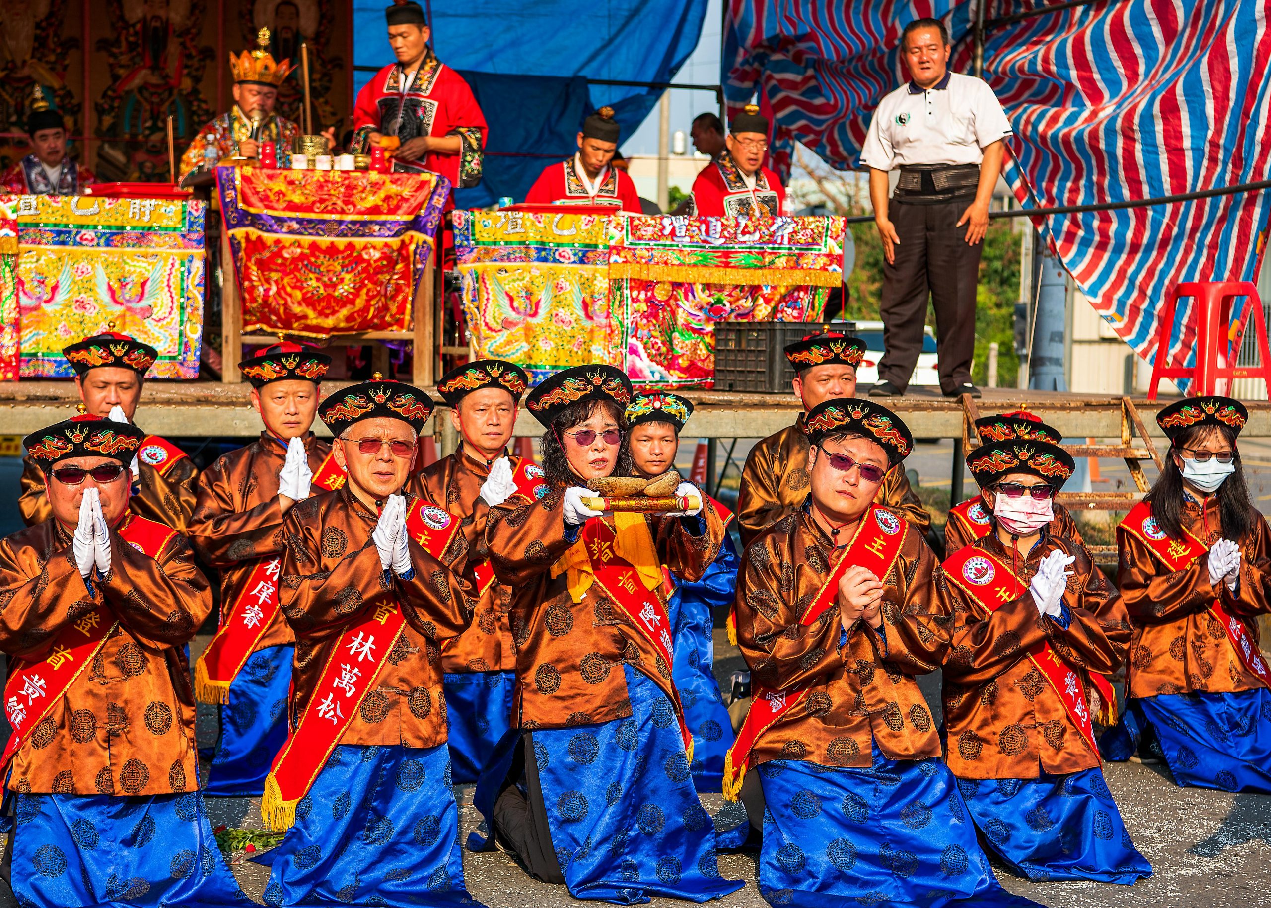 Colorful traditional ceremony in Tainan, Taiwan with participants in vibrant costumes and ritual performance.